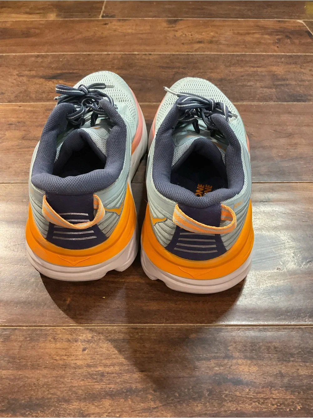 Hoka Blue Athletic Shoes with Orange and Pink Accents